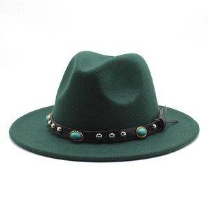 Close-up of leather hat band with silver studs and turquoise on dark green felt fedora