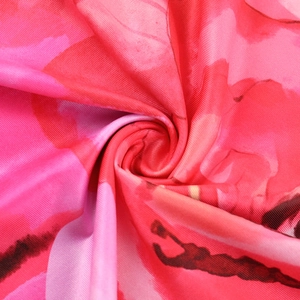 Dettaglio macro del tessuto floreale setoso con trama rosa e morbido drappeggio
