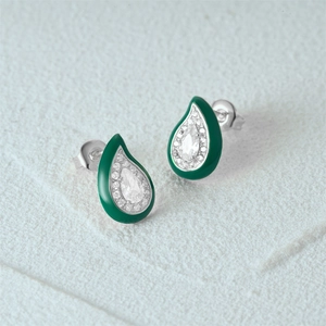 Macro view of teardrop sterling silver earrings with green enamel and clear crystals