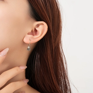 S925 Sterling silver hoop earrings with blue zircon bee pendants worn by a model