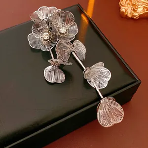 Elegant silver flower brooch with sparkling rhinestones and delicate tassel hollow design