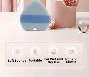 Macro detail of heart-shaped blue makeup sponge puff with soft elastic finger strap