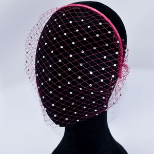 Detail of rose red birdcage veil headband with sparkling rhinestones for party wear