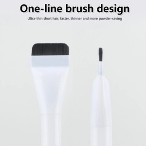 Macro detail of ultra-thin flat foundation brush with white handle and black bristles