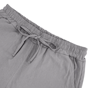 Detail of grey linen polo set shorts featuring elastic waistband and adjustable drawstrings