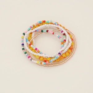 Macro view of multi-layered bohemian seed bead bracelet set with elastic design