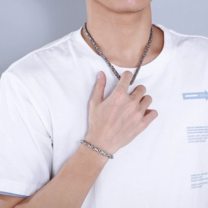 Silver stainless steel Byzantine square link necklace and bracelet set worn by a male model