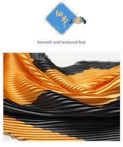 Macro detail of pleated silk scarf featuring bold yellow and black color contrast