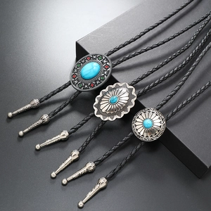 Three vintage Bolo ties with turquoise insets on black braided PU leather cords