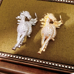 Detail of vintage horse brooches in gold and silver finish with sparkling cubic zirconia