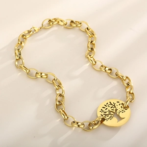 Close-up of golden chunky chain necklace with detailed Tree of Life cutout pendant