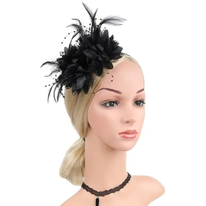 Close-up of elegant black feather and mesh hair clip on model for weddings and parties