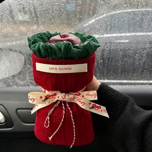 Christmas apple gift bouquet with red knit fabric and green crepe paper wrapping