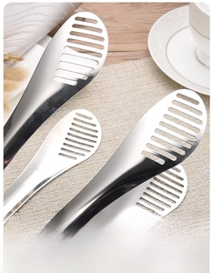 Macro detail of polished stainless steel food tongs with hollowed-out drainage design
