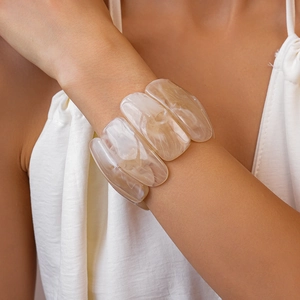 Close-up of marble pattern acrylic rectangle bracelet on female model's wrist