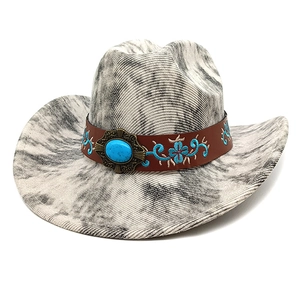 Detail of western cowboy hat featuring turquoise buckle and floral embroidered band