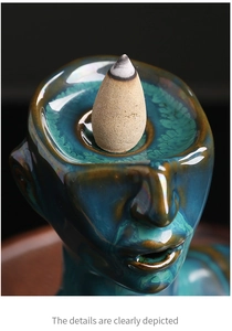 Macro detail of blue-green ceramic backflow incense burner showing glossy glaze and texture