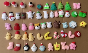 Flat lay of diverse Christmas resin charms including snowmen, trees, and reindeer figures