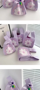 Detail of purple knitted gift bags with white floral patterns and 3D flower decorations