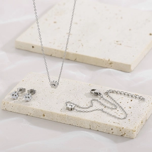 Silver stainless steel paw print jewelry set including necklace, bracelet and stud earrings