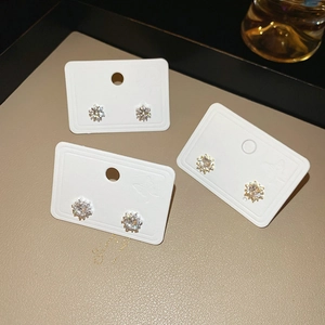 Detail view of silver snowflake earrings with sparkling zircons on jewelry cards