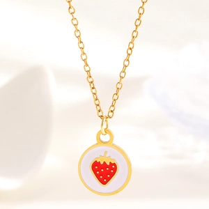 Close-up of strawberry enamel pendant on a golden stainless steel chain necklace