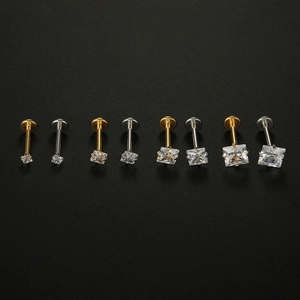 Detail of square zircon labret studs in gold and silver 316L stainless steel finish