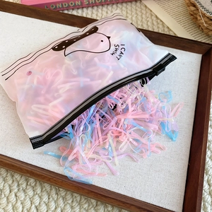 Macro shot of colorful high-elastic hair ties in a frosted zipper bag with duck design
