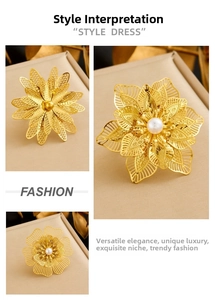 Detail of gold-plated hollow petal flower ring with central white pearl on a jewelry box