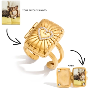 Detail of opening 18K gold plated photo locket ring with sunburst pattern and heart crystal