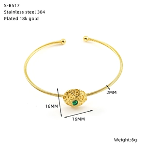 Macro detail of 18K gold plated stainless steel cable bracelet with turquoise evil eye bead