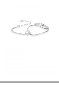 Macro detail of S925 sterling silver knotted bracelet with double rings and heart tag