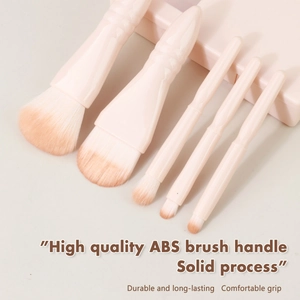 Detailed view of pink travel makeup brushes with soft gradient fibers and ABS handles