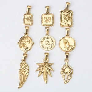 Set of 9 gold stainless steel charms including butterfly cross leaf and wing pendants