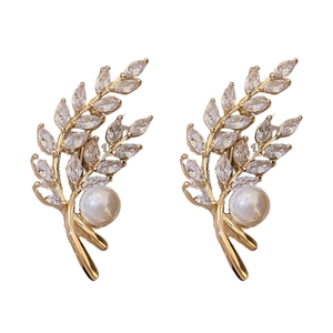 Gold-plated wheat leaf earrings with pearls and marquise zircons on a white background