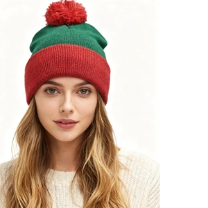 Christmas knit beanie hat with large red pom pom and festive green color block design