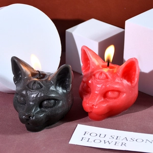 Gothic three-eyed cat candles in black and red colors with artistic glitter wax finish
