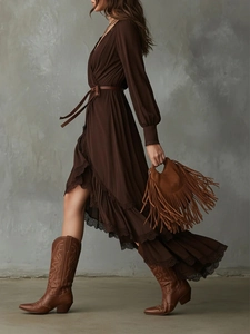 Bohemian V-neck brown dress with lace trim and tassel bag shown in motion