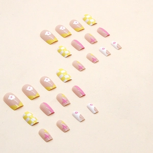 Colorful square press-on nails with yellow checkerboard and pink floral patterns