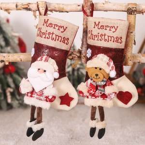 Set of 2 faux fur Christmas stockings with Santa and Bear dolls on wooden branches
