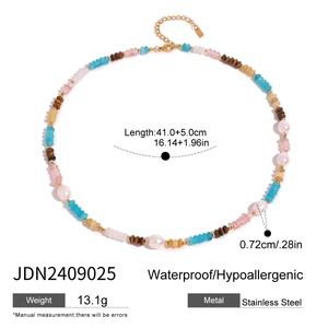 Detail of beaded necklace with natural stones, white pearls and gold stainless steel clasp