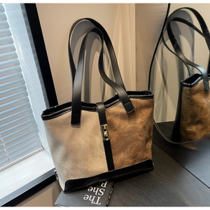 Detail of color-block suede tote bag in beige and brown with golden metal buckle