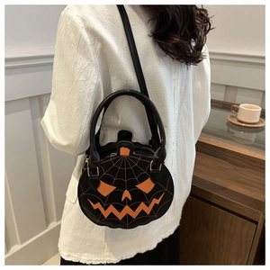 Detail of creative pumpkin bag with orange Jack-o'-lantern face and spider web pattern