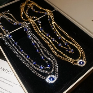 Detail of evil eye pendant layered necklace with rhinestones in black velvet box