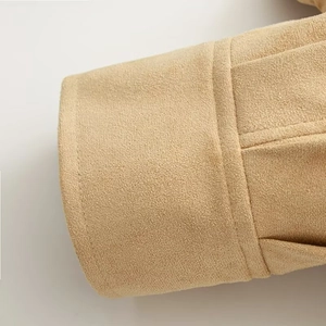 Close-up of camel suede jacket cuff with premium double stitching on soft fabric
