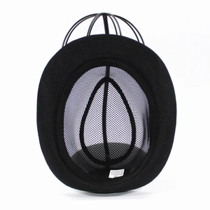Detail view of the breathable honeycomb mesh lining and size label inside the black fedora