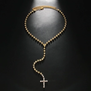 Sparkling gold cross pendant necklace with rhinestones on a minimalist Y-chain