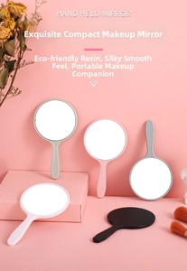 Detail of cute handheld makeup mirrors in multiple colors with ergonomic resin handles