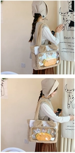 Detail of the soft plush material and transparent PVC window on the beige cat bag