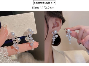 Detail of long tassel earrings with white pearls and sparkling cubic zirconia dangles